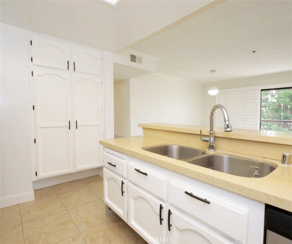 13601 Del Monte Drive, Unit 75 Seal Beach, CA 90740 - Photo 10 of 28 a kitchen with a sink and cabinets