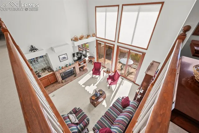 a living room with furniture and a floor to ceiling window