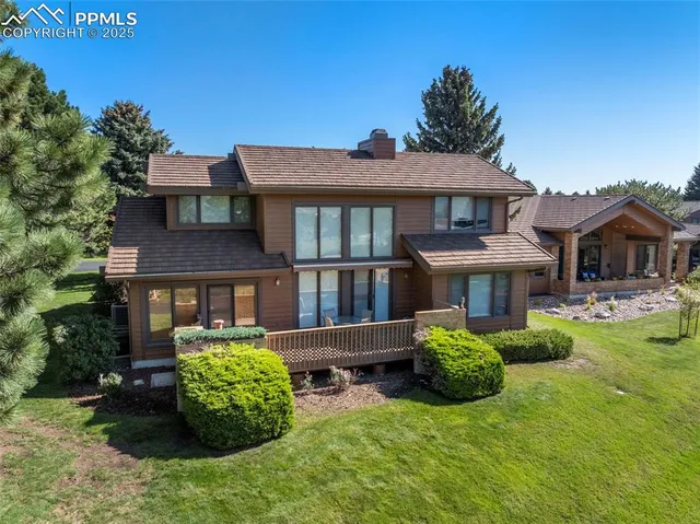 a view of a house with a backyard and a garden