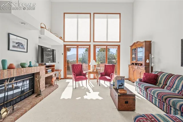 a living room with furniture fireplace and flat screen tv