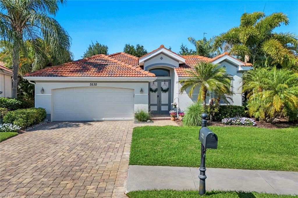 a front view of a house with a yard and garage