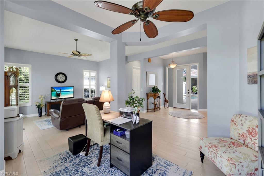 3232 Sundance Circle Naples, FL 34109 - Photo 11 of 50 a living room with furniture and a large window