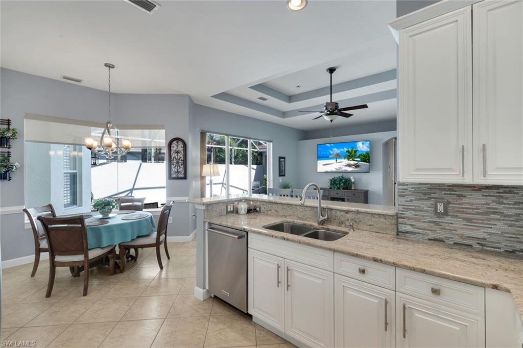3232 Sundance Circle Naples, FL 34109 - Photo 13 of 50 a kitchen with a sink and a refrigerator
