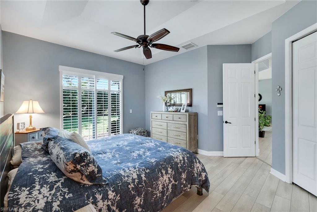 3232 Sundance Circle Naples, FL 34109 - Photo 18 of 50 a bedroom with a large bed and a window