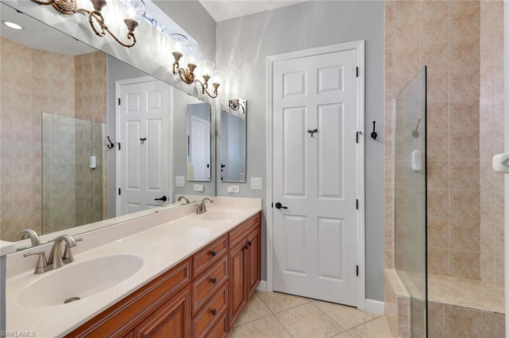 3232 Sundance Circle Naples, FL 34109 - Photo 20 of 50 a bathroom with a double vanity sink mirror and double