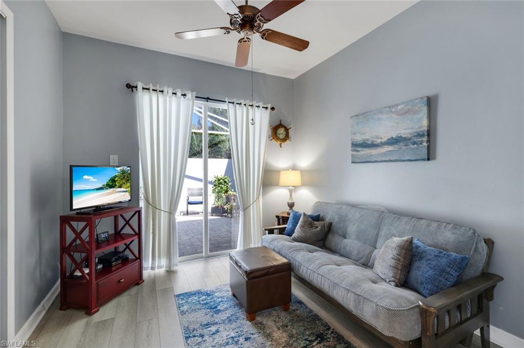 3232 Sundance Circle Naples, FL 34109 - Photo 21 of 50 a living room with furniture and a flat screen tv