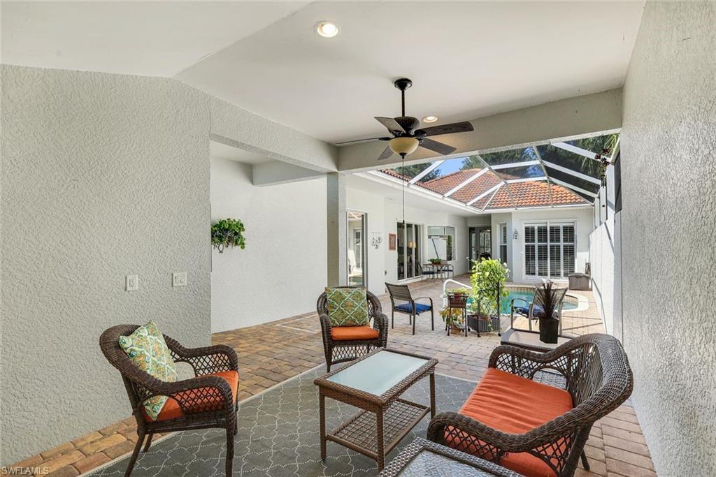 3232 Sundance Circle Naples, FL 34109 - Photo 28 of 50 a living room with a couch and a ceiling fan
