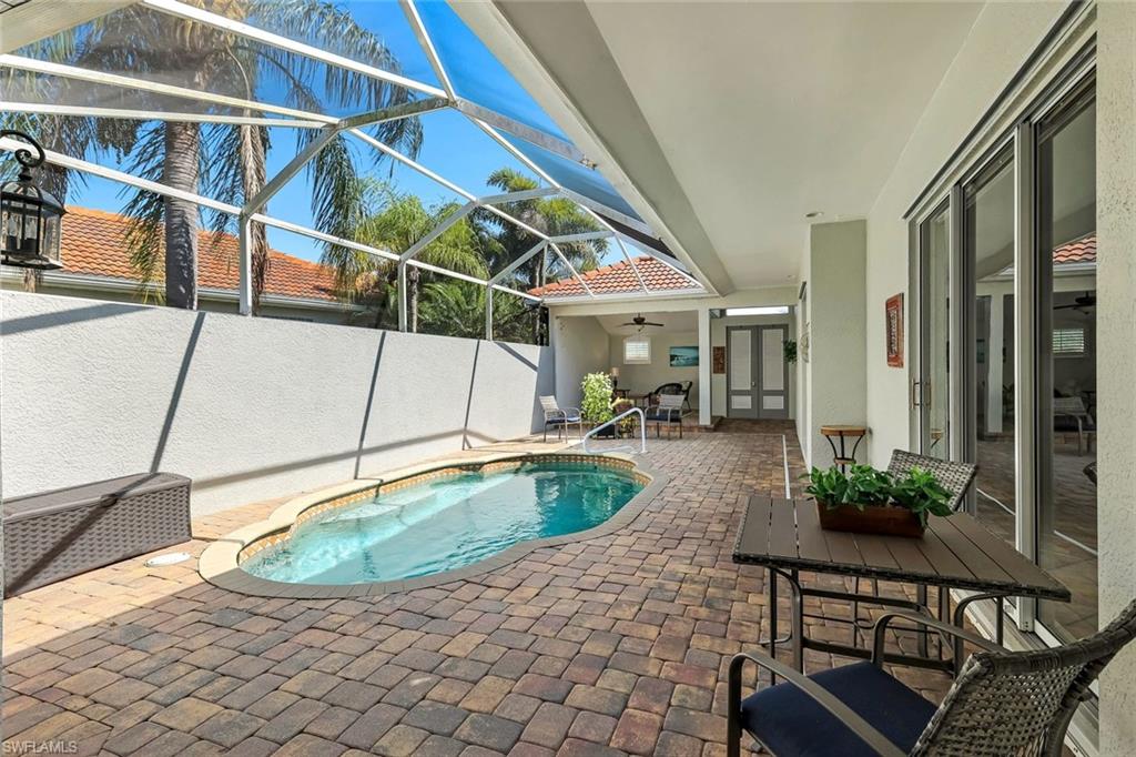 3232 Sundance Circle Naples, FL 34109 - Photo 31 of 50 a swimming pool with outdoor seating