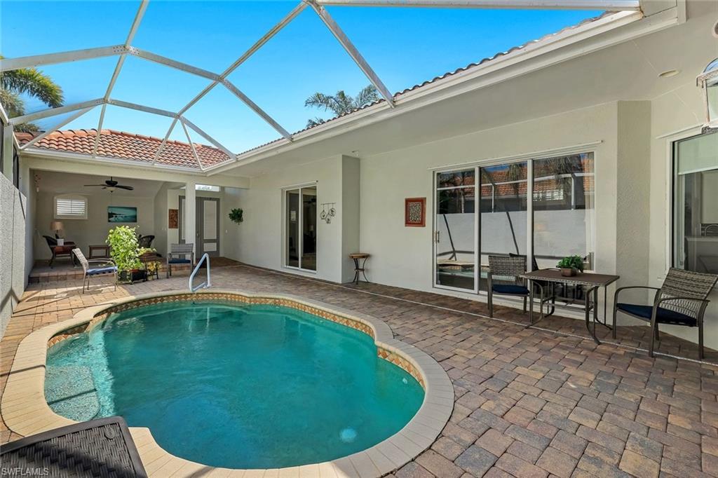 3232 Sundance Circle Naples, FL 34109 - Photo 32 of 50 a swimming pool with outdoor seating