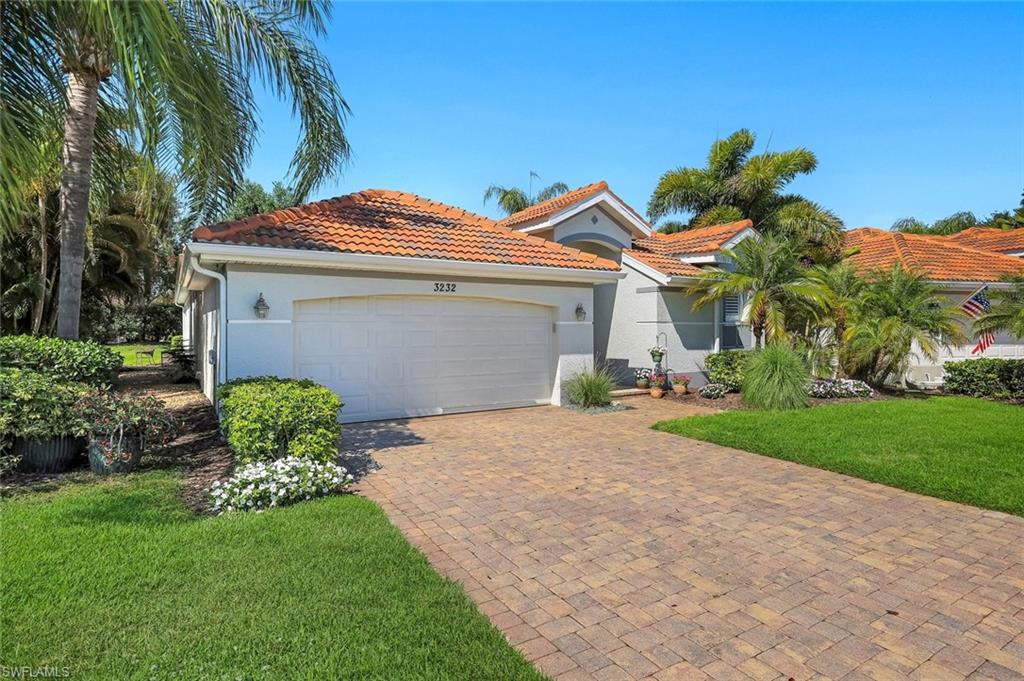 3232 Sundance Circle Naples, FL 34109 - Photo 34 of 50 a front view of a house with a yard and a garage