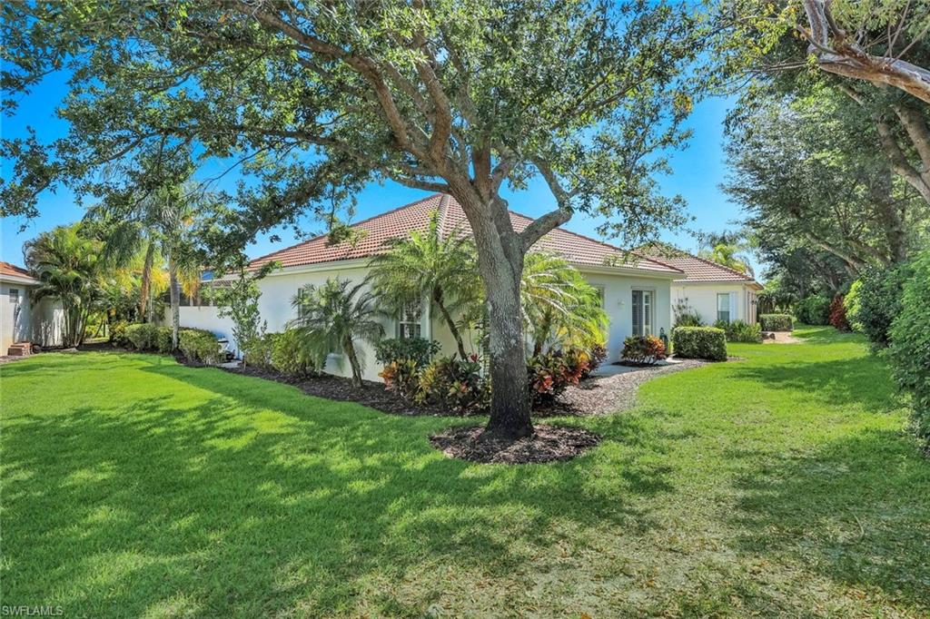 3232 Sundance Circle Naples, FL 34109 - Photo 36 of 50 a view of a house with a yard