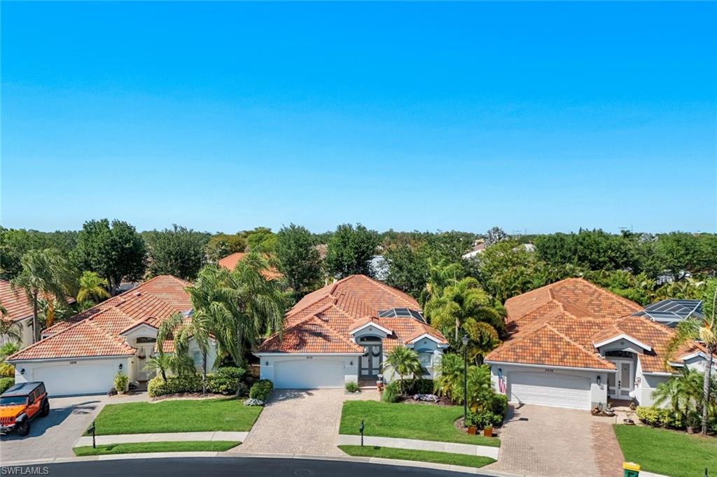 3232 Sundance Circle Naples, FL 34109 - Photo 37 of 50 an aerial view of residential houses with outdoor space and street view