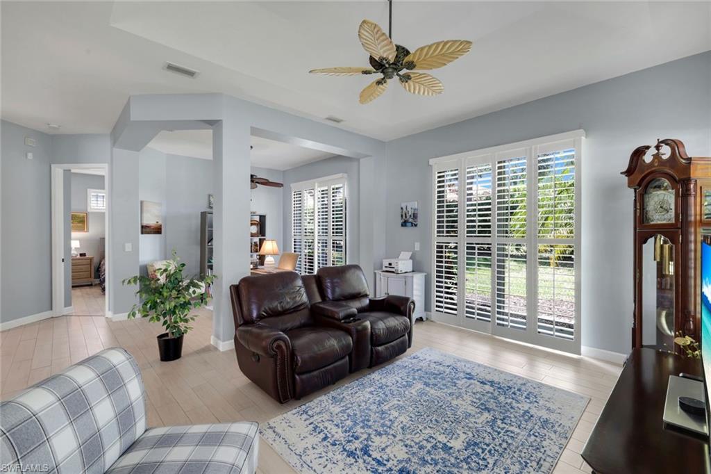 3232 Sundance Circle Naples, FL 34109 - Photo 4 of 50 a living room with furniture and a flat screen tv