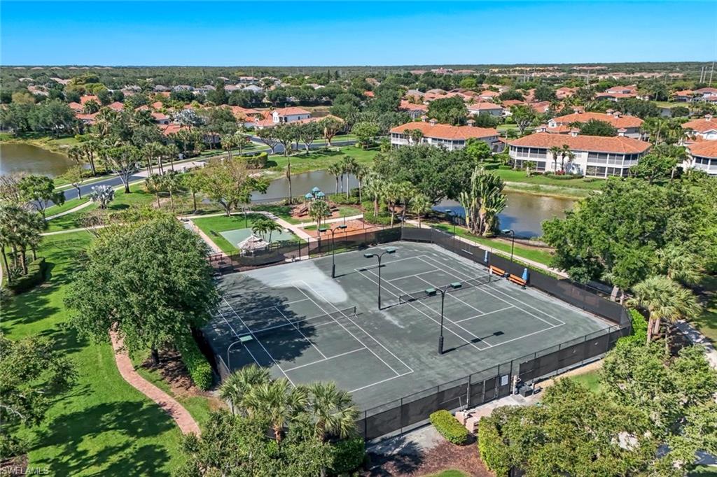 3232 Sundance Circle Naples, FL 34109 - Photo 48 of 50 an aerial view of residential houses with outdoor space and parking