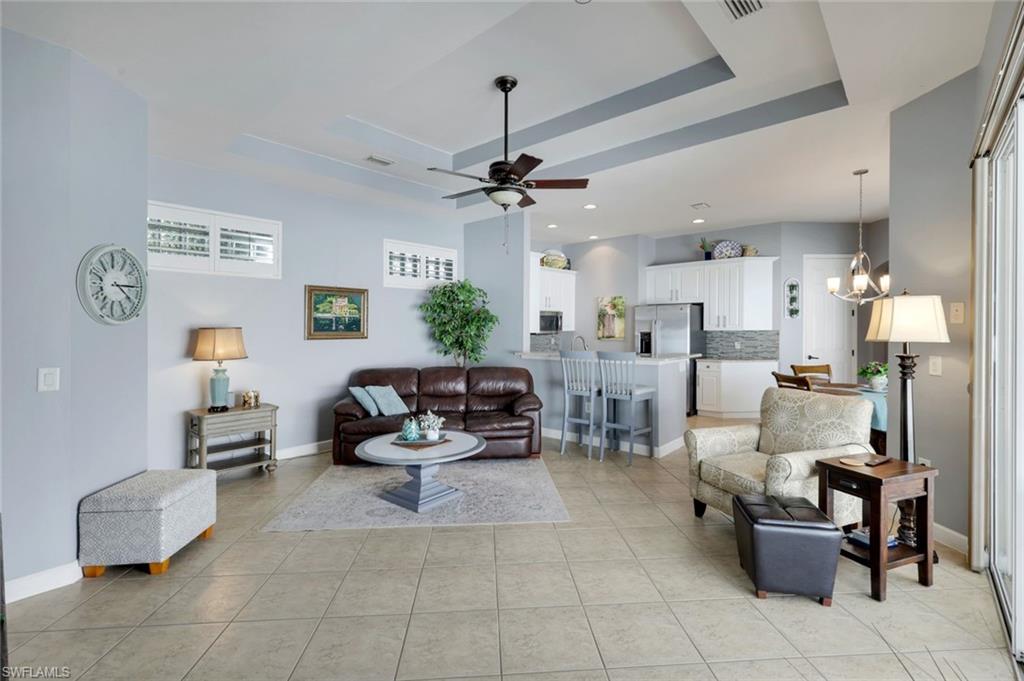 3232 Sundance Circle Naples, FL 34109 - Photo 7 of 50 a living room with furniture and a chandelier