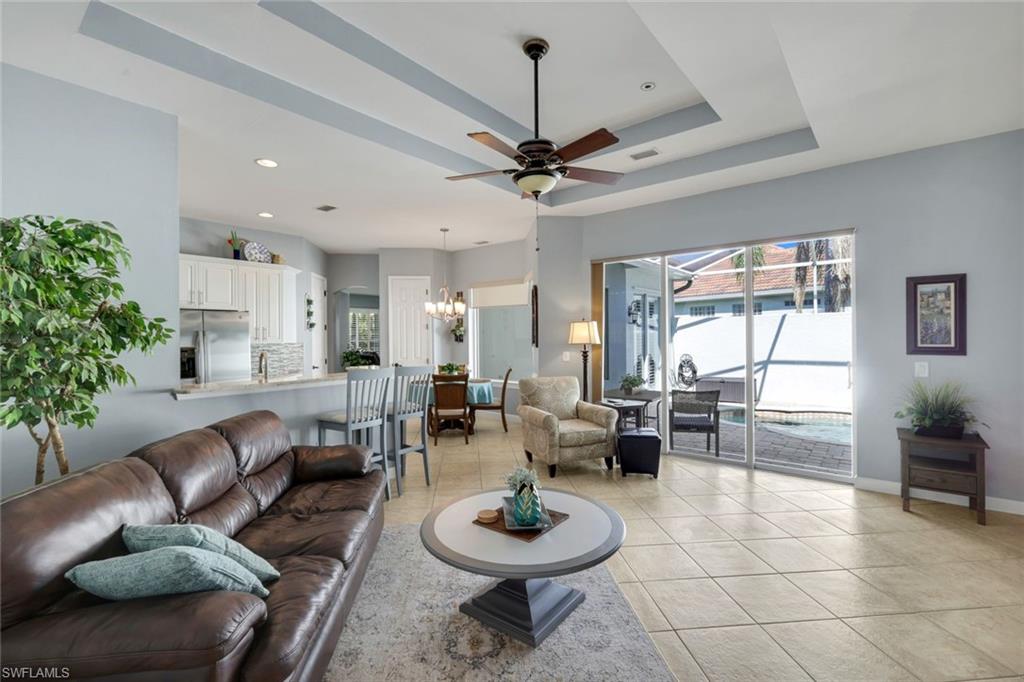 3232 Sundance Circle Naples, FL 34109 - Photo 8 of 50 a living room with furniture a window and a chandelier
