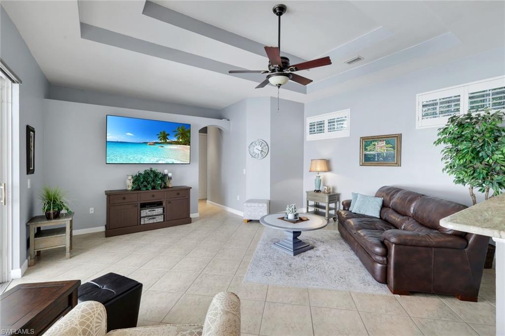 3232 Sundance Circle Naples, FL 34109 - Photo 9 of 50 a living room with furniture and a flat screen tv