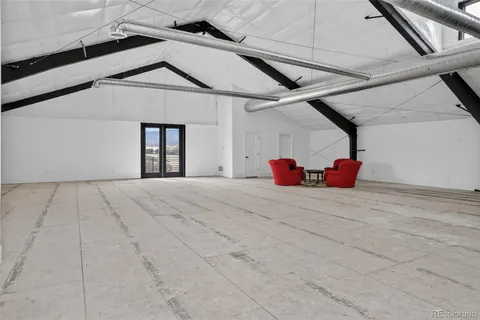 a bedroom with a bed and a white umbrella