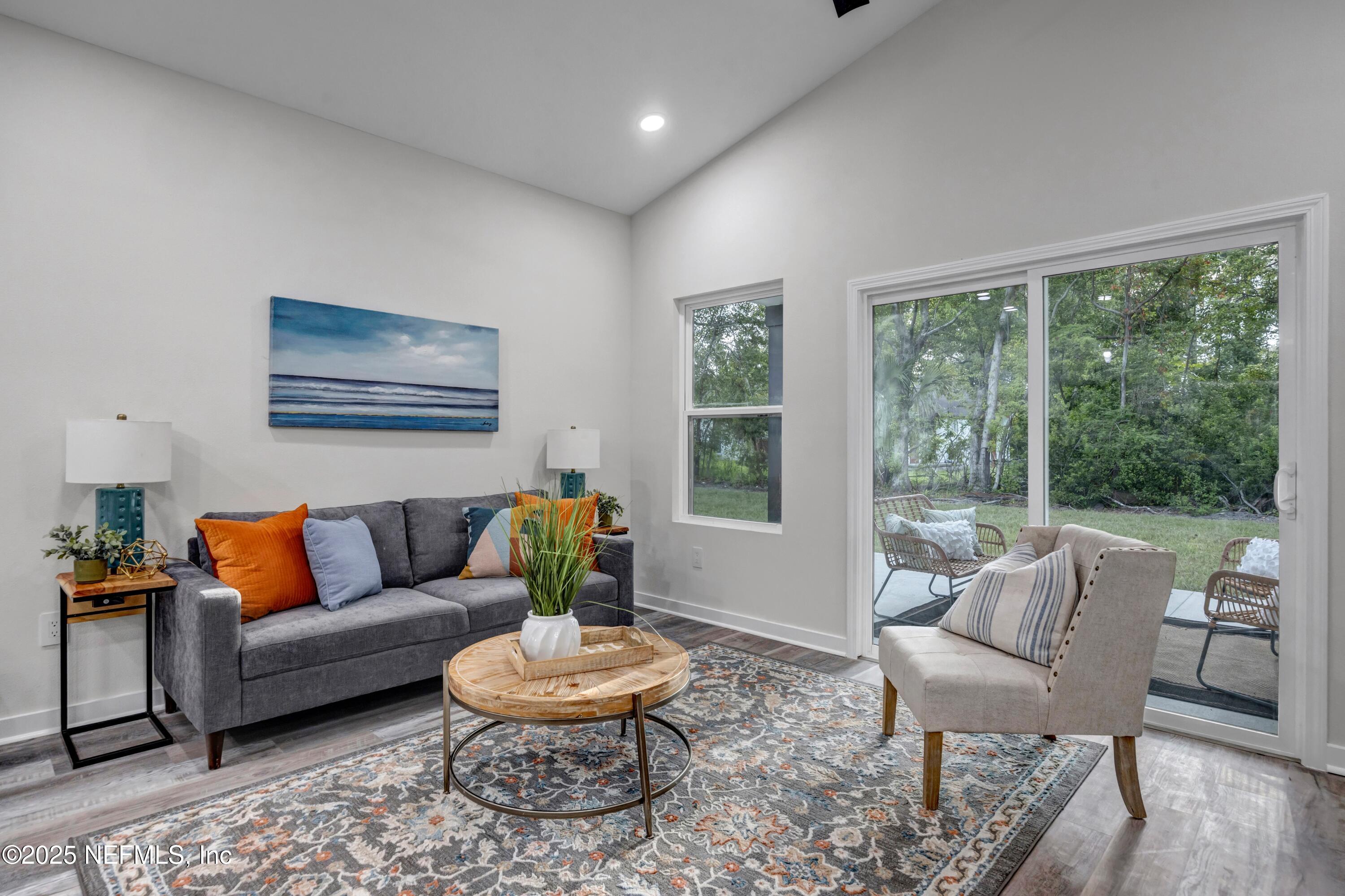 34 Delmonte Street Baldwin, FL 32234 - Photo 13 of 38 a living room with furniture and a large window