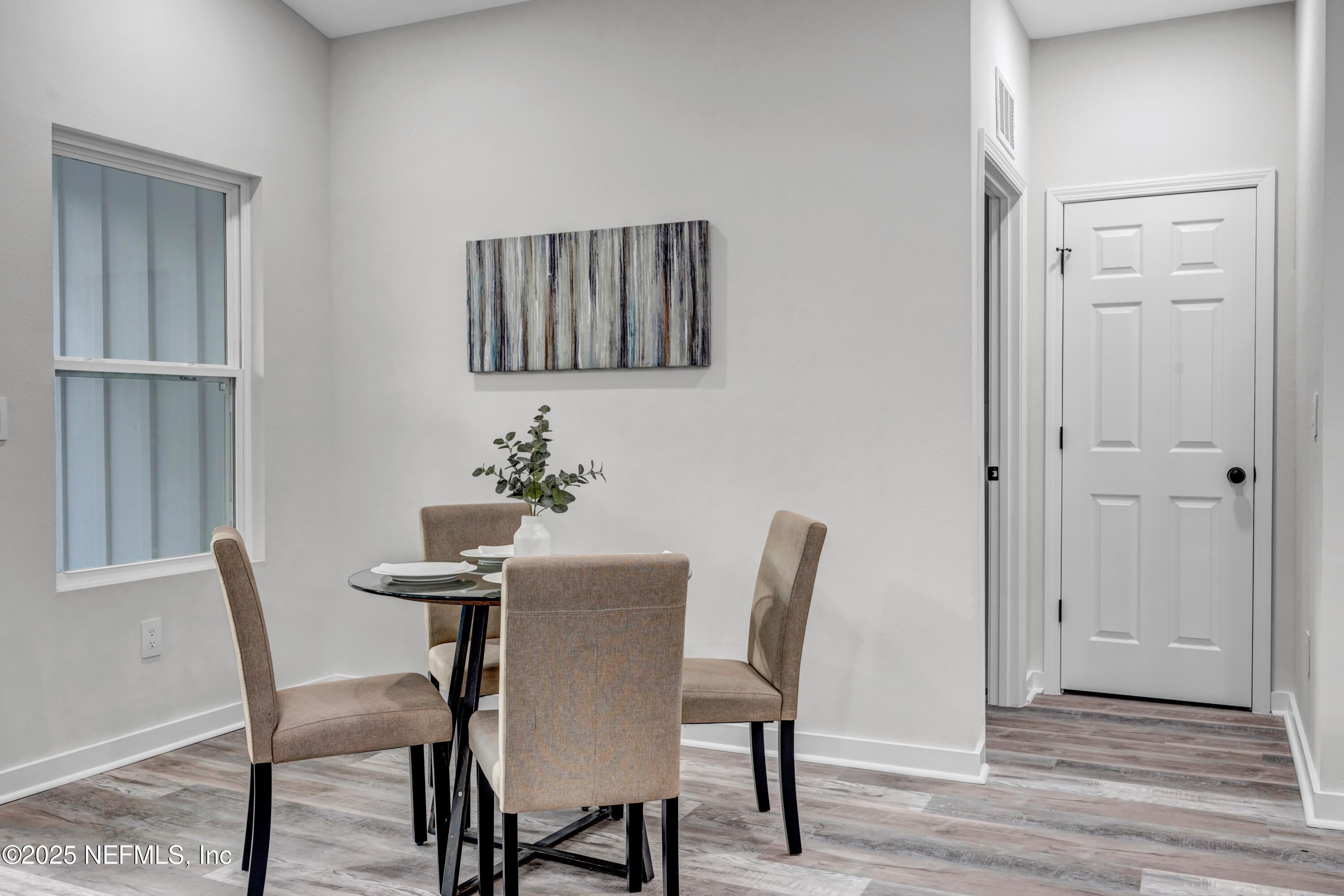 34 Delmonte Street Baldwin, FL 32234 - Photo 16 of 38 a view of a dining room with furniture and wooden floor