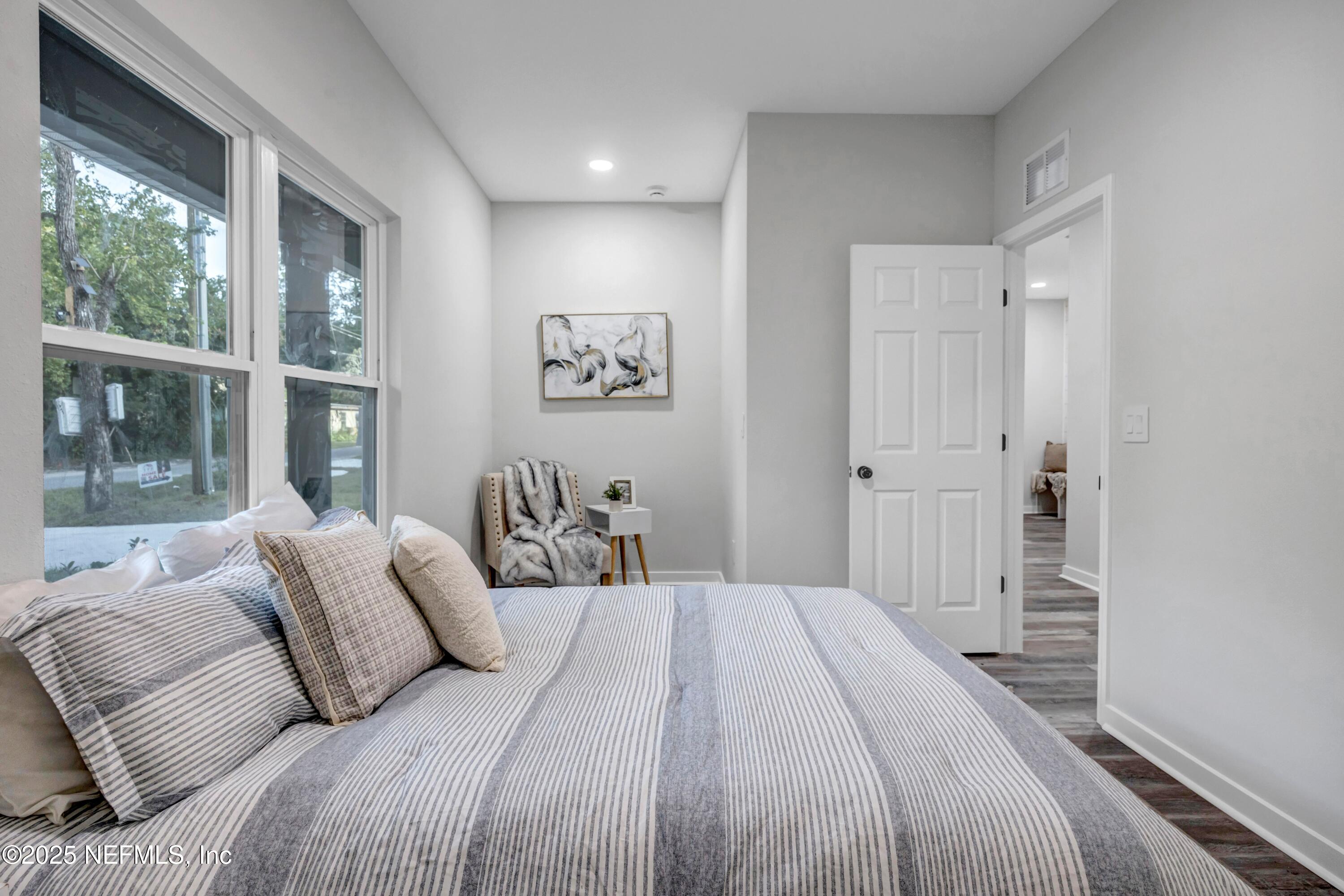 34 Delmonte Street Baldwin, FL 32234 - Photo 27 of 38 a bedroom with a large bed and a large window