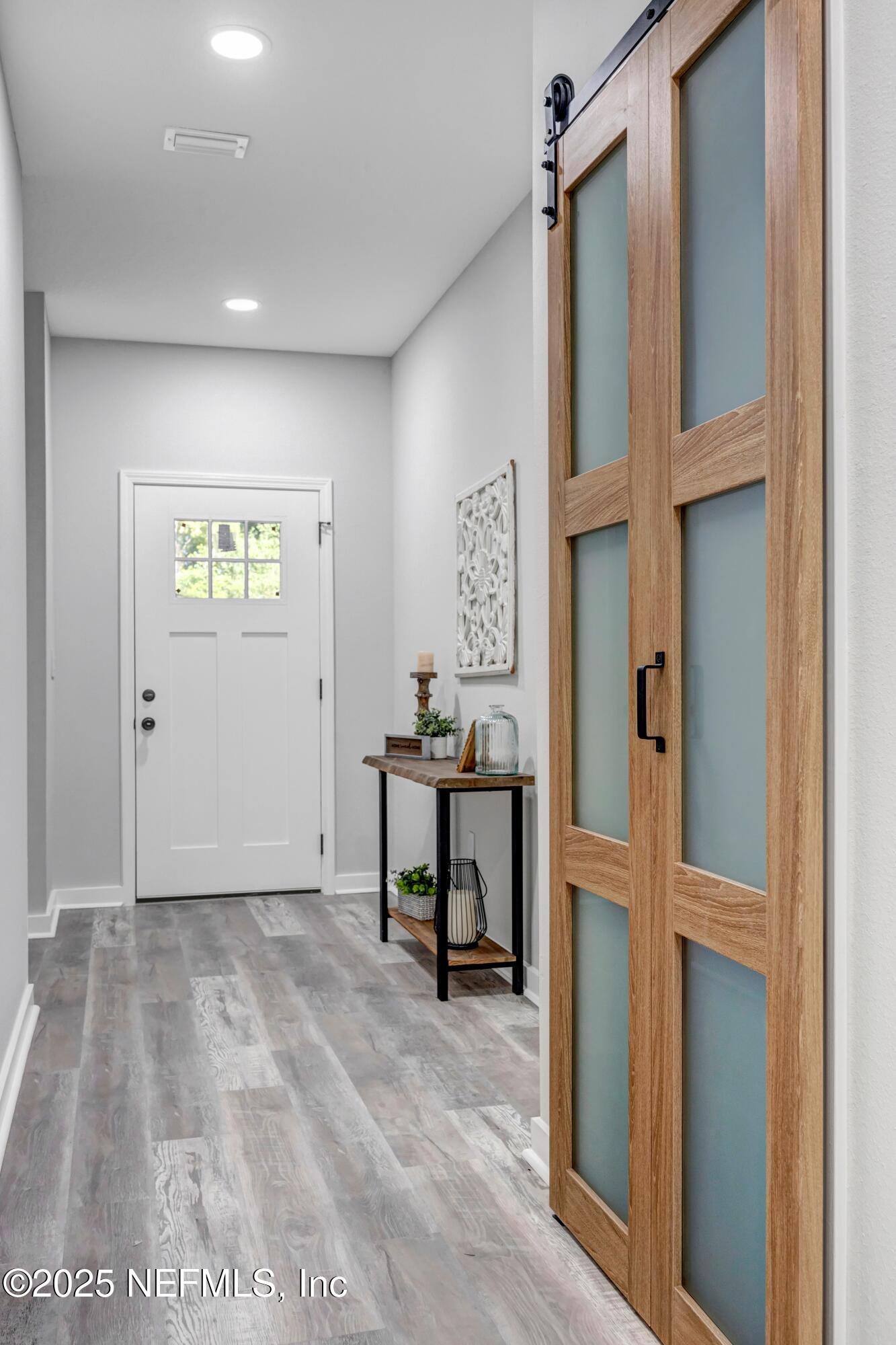34 Delmonte Street Baldwin, FL 32234 - Photo 6 of 38 a view of an entryway with wooden floor
