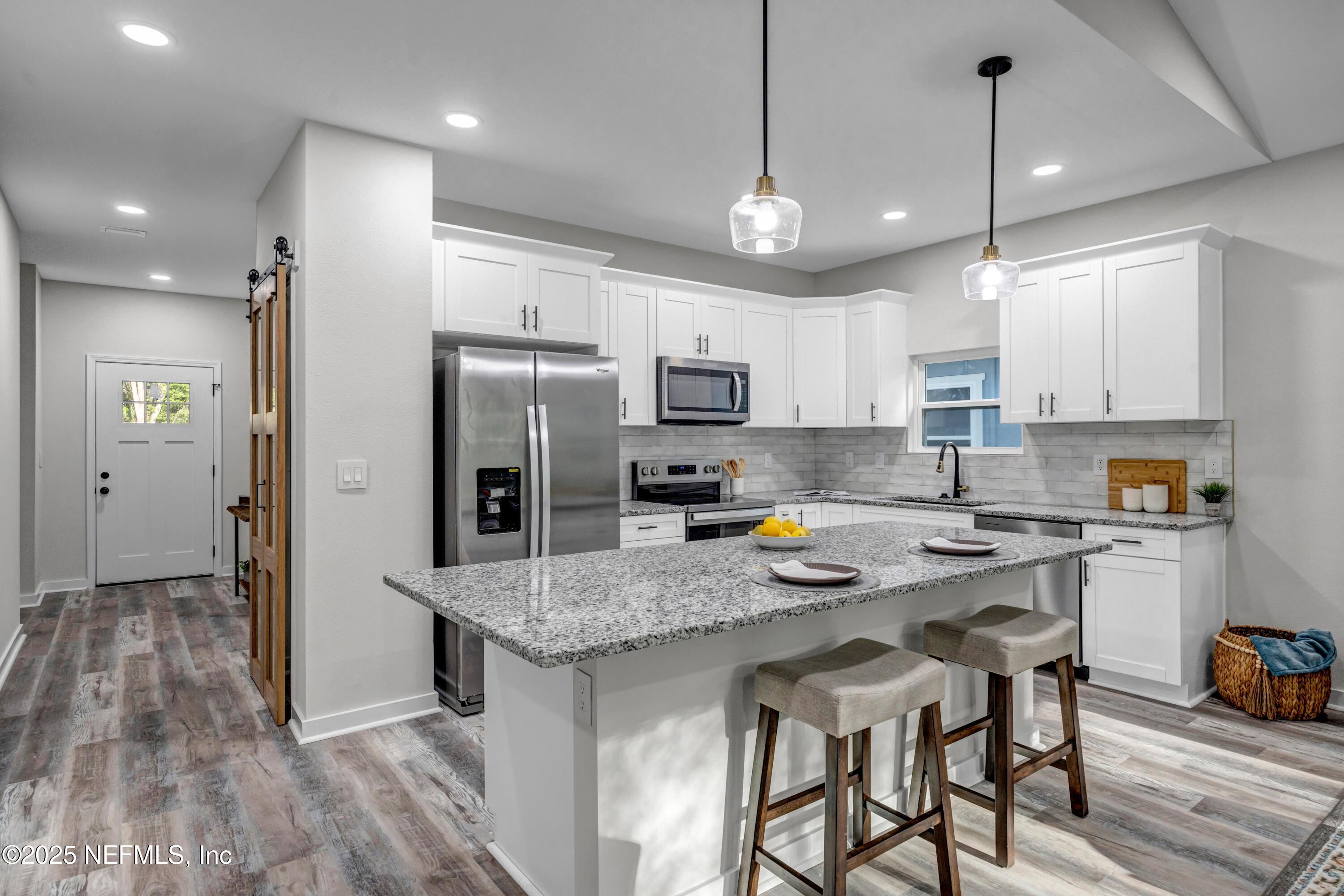34 Delmonte Street Baldwin, FL 32234 - Photo 8 of 38 a kitchen with a refrigerator a stove a sink and a center island