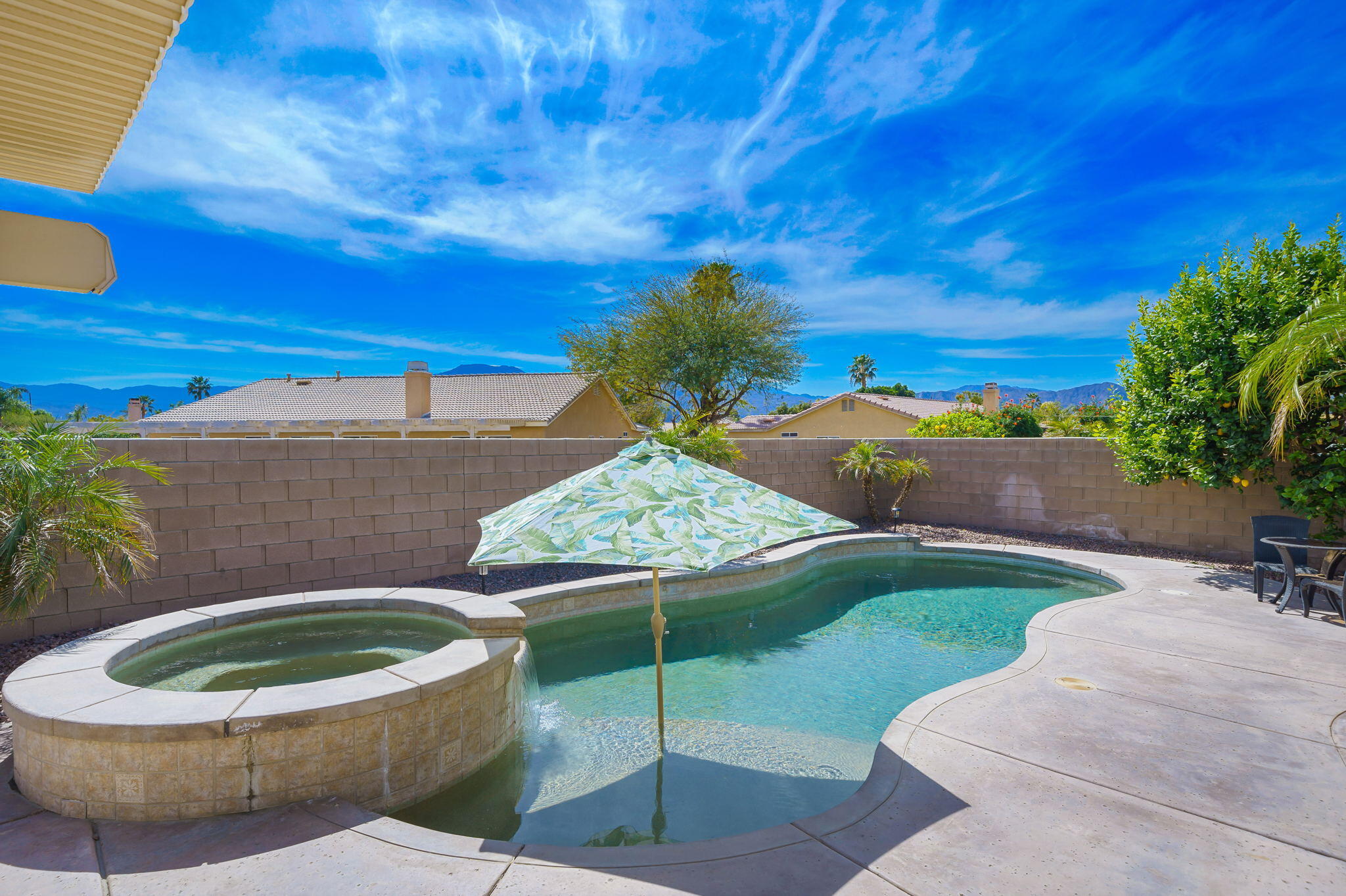 a view of a backyard with plants and patio