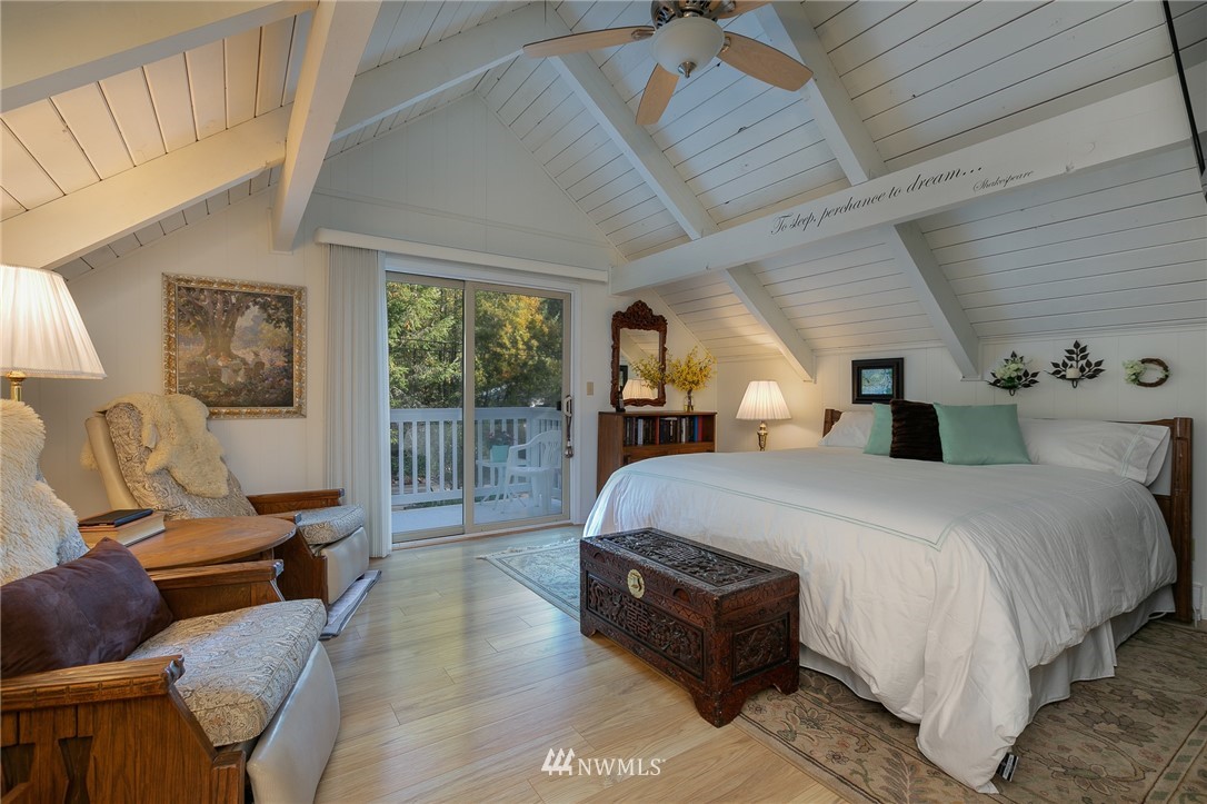 8916 Johnson Road Anderson Island, WA 98303 - Photo 14 of 22 a spacious bedroom with a bed a table and chair