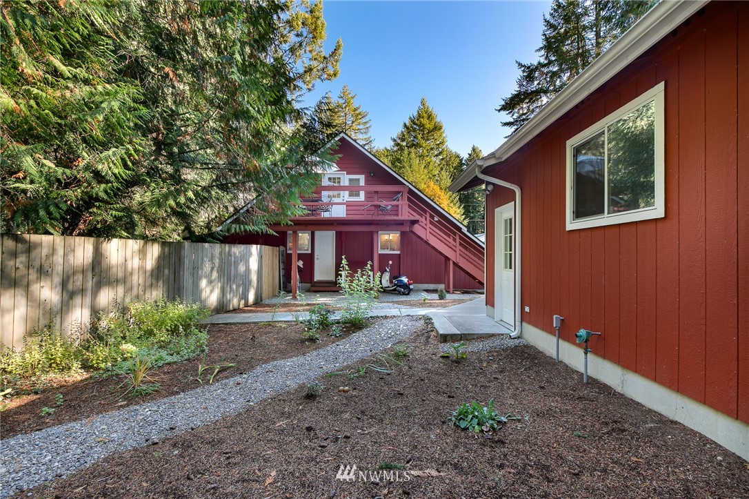 8916 Johnson Road Anderson Island, WA 98303 - Photo 3 of 22 a view of a house with a yard and tree s