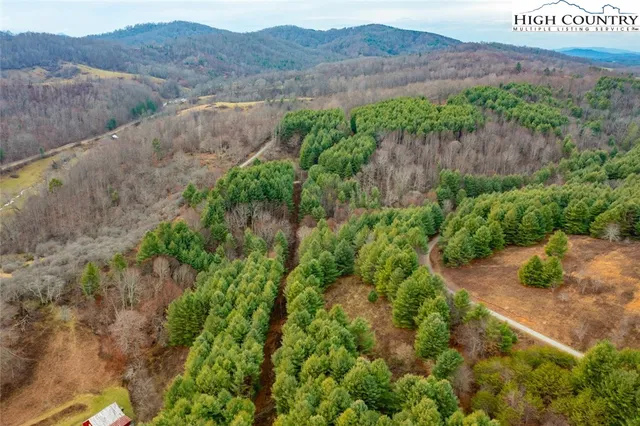 a view of a lush green hillside and a building