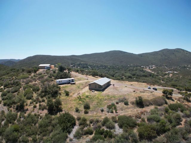a view of a mountain in the distance in a field