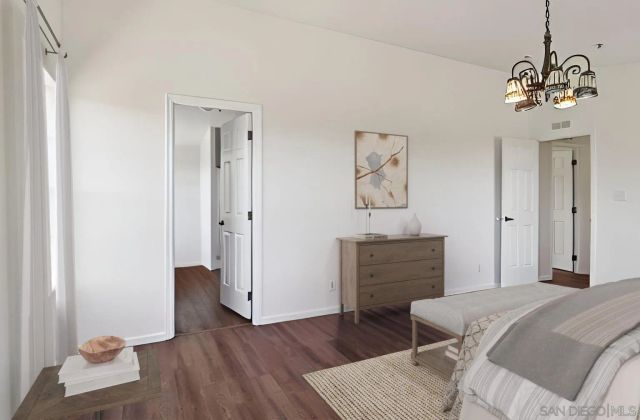 a view of a room with wooden floor and a window