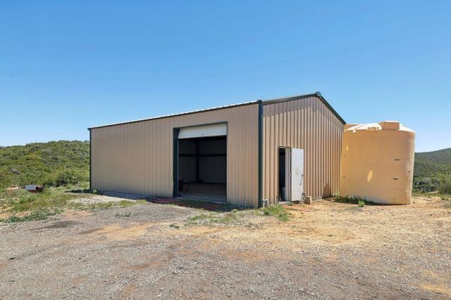 a backyard of a house with a yard and outdoor seating