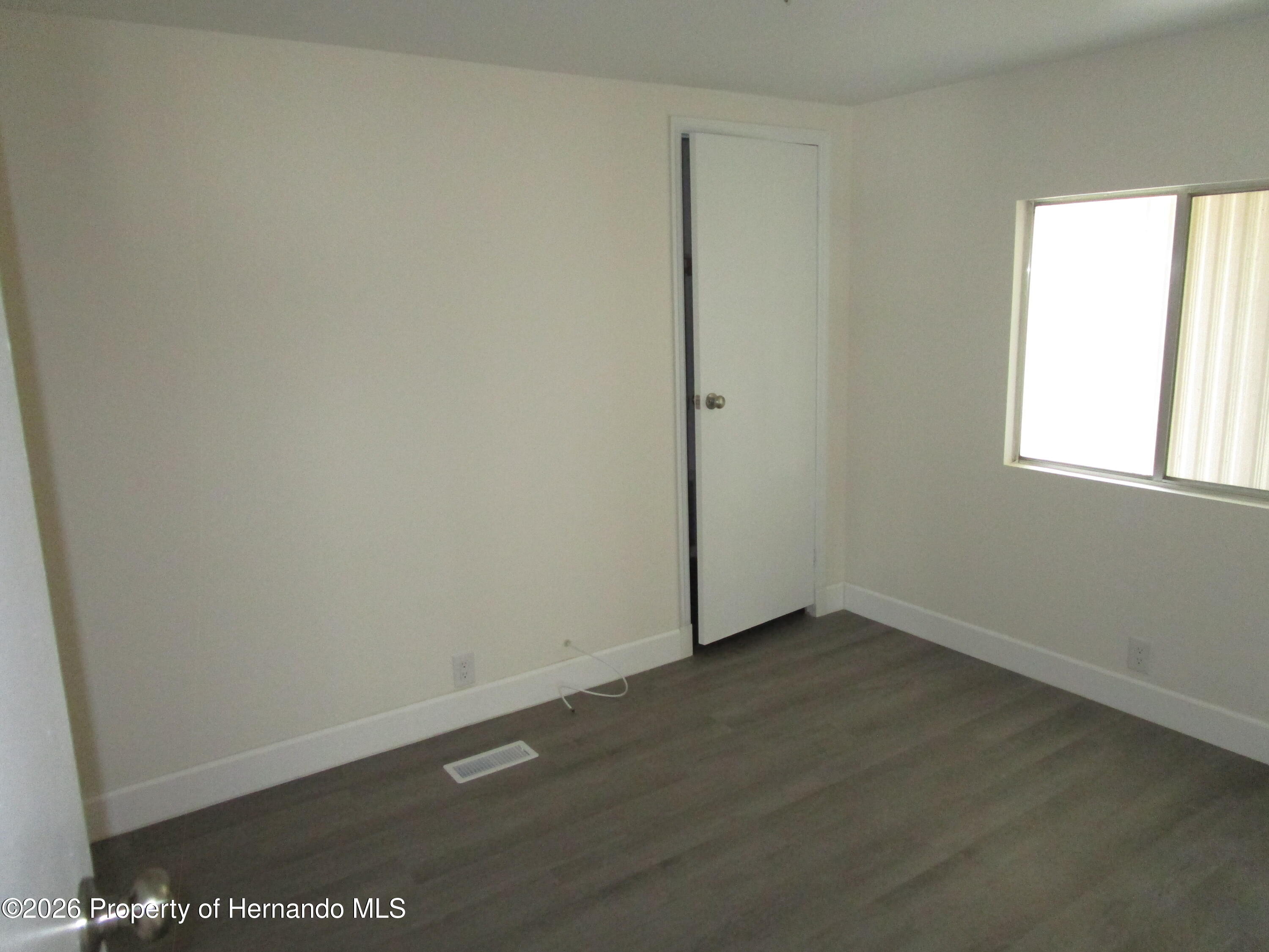 14790 Rialto Avenue, Unit 3 Brooksville, FL 34613 - Photo 8 of 15 an empty room with a window