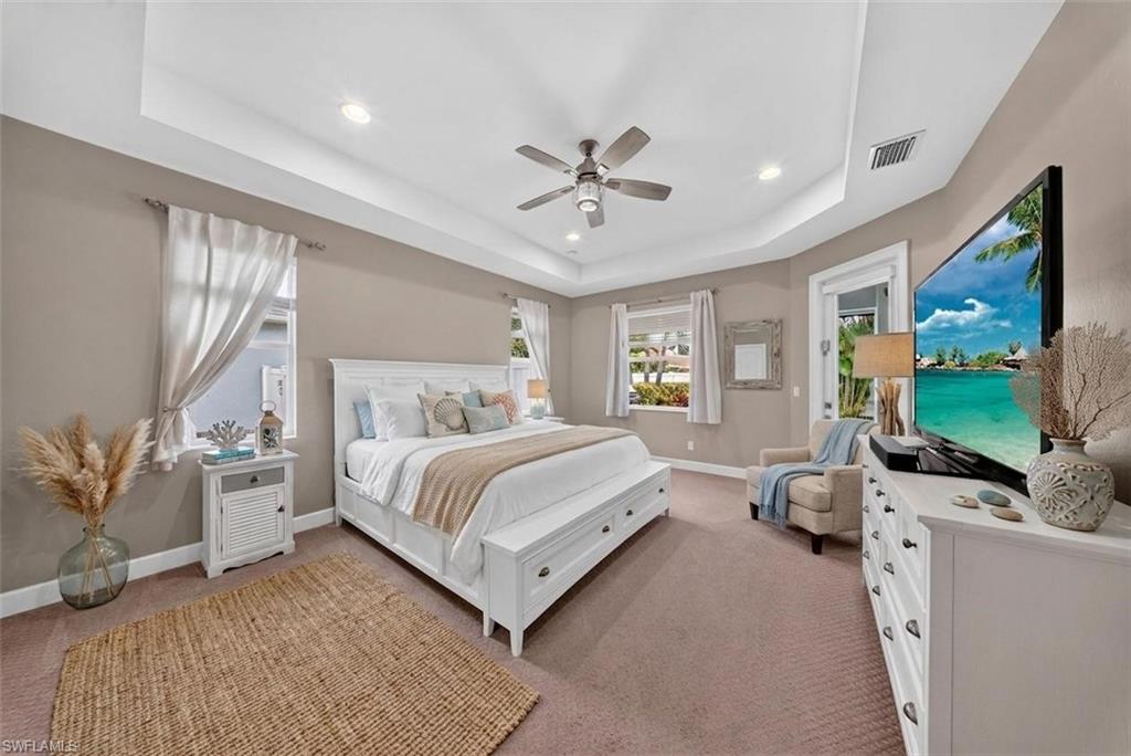 37 Johnnycake Drive Naples, FL 34110 - Photo 5 of 33 Spacious bedroom featuring a tray ceiling with recessed lighting and a ceiling fan