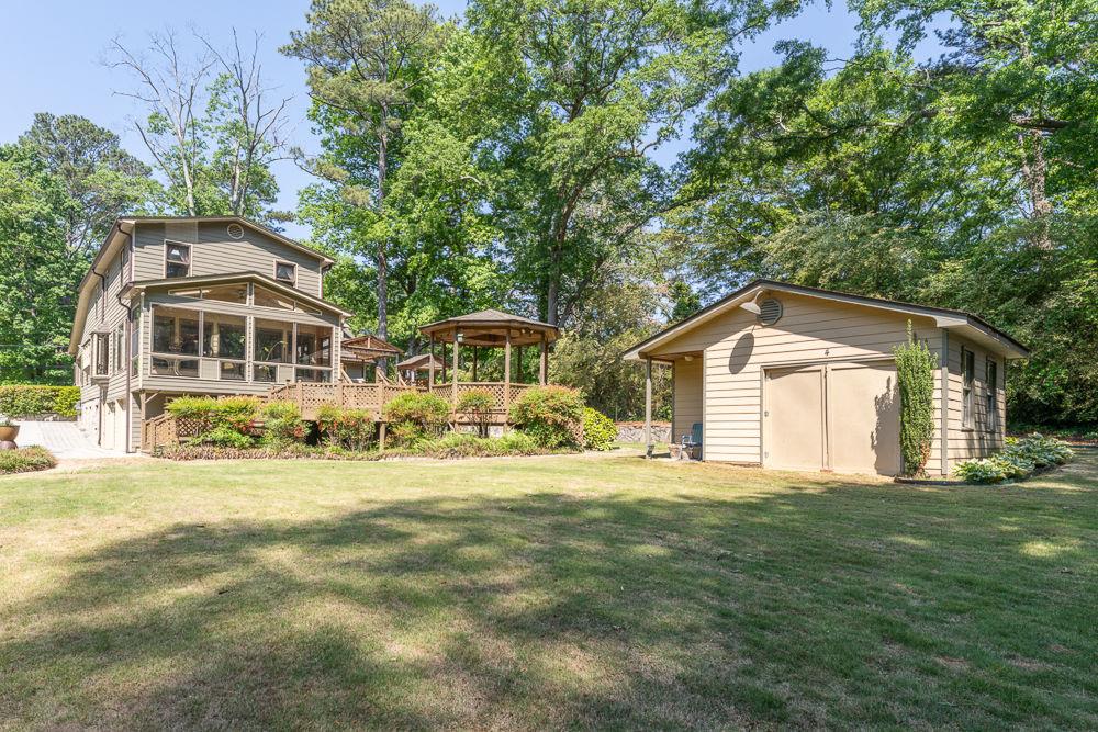 2915 Ashford Road Northeast Brookhaven, GA 30319 - Photo 11 of 60 a front view of a house with a yard and trees