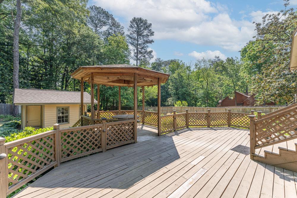 2915 Ashford Road Northeast Brookhaven, GA 30319 - Photo 12 of 60 a view of a deck with furniture and wooden floor