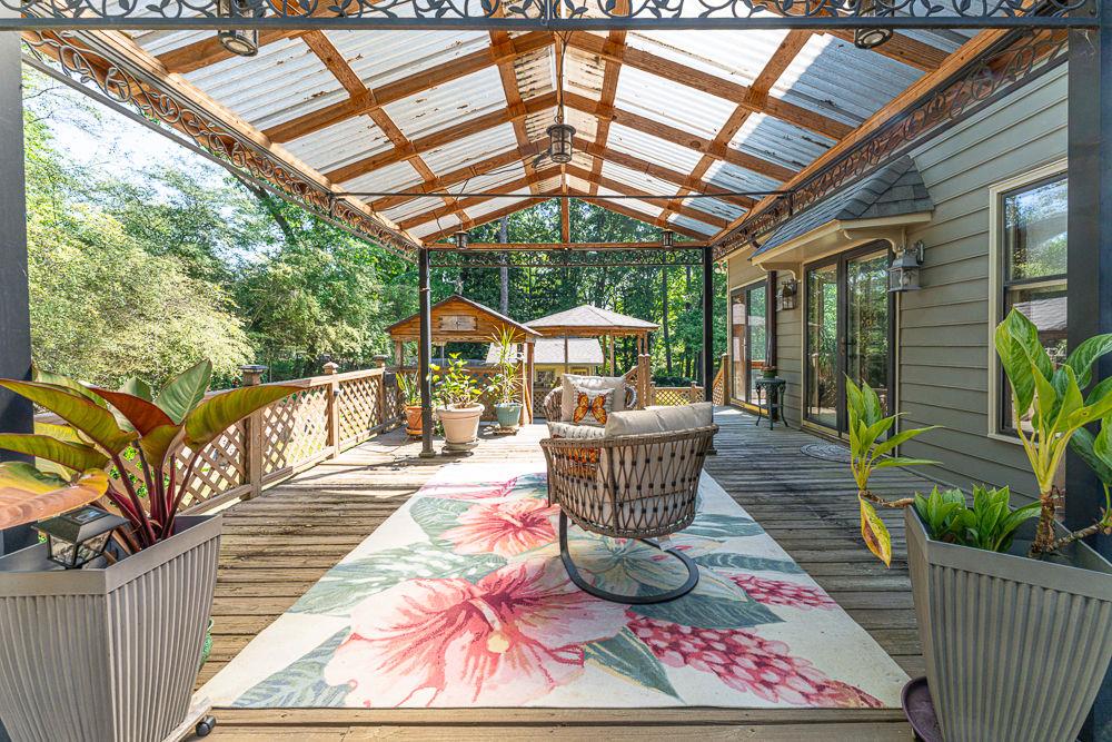 2915 Ashford Road Northeast Brookhaven, GA 30319 - Photo 15 of 60 a view of a patio with a table chairs and wooden floor