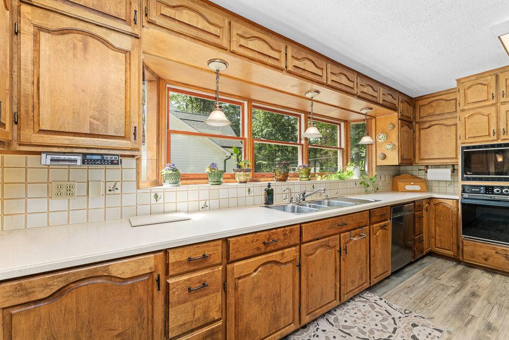 2915 Ashford Road Northeast Brookhaven, GA 30319 - Photo 29 of 60 a kitchen with stainless steel appliances granite countertop a sink and a window