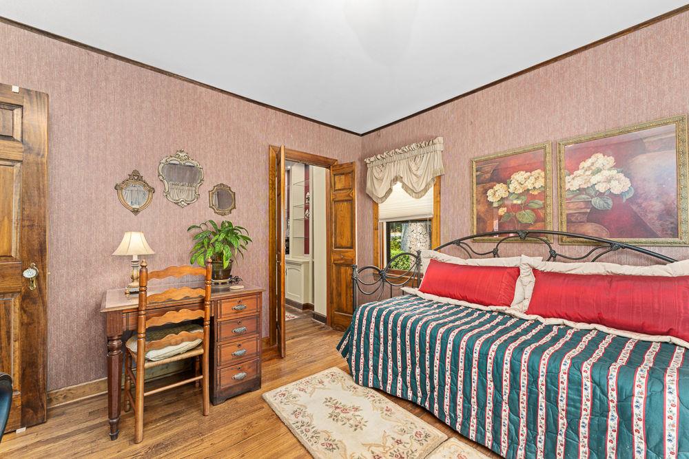 2915 Ashford Road Northeast Brookhaven, GA 30319 - Photo 33 of 60 a bedroom with a bed and wooden floor
