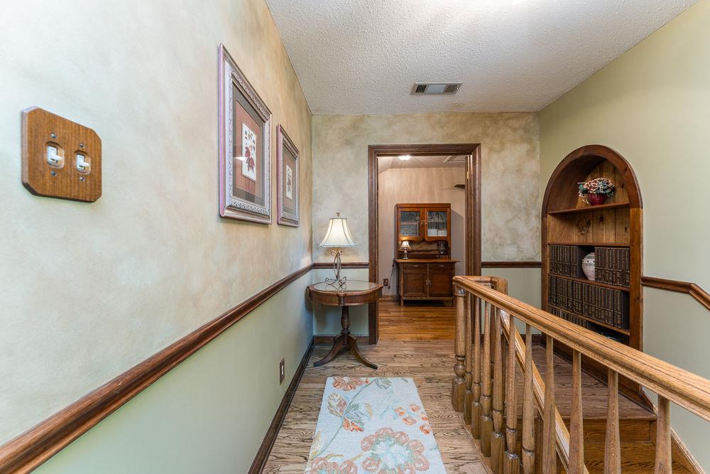 2915 Ashford Road Northeast Brookhaven, GA 30319 - Photo 46 of 60 a view of a hallway with wooden floor and staircase