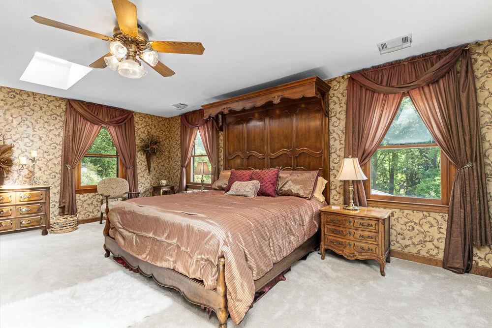 2915 Ashford Road Northeast Brookhaven, GA 30319 - Photo 53 of 60 a bedroom with a bed dresser and a large window