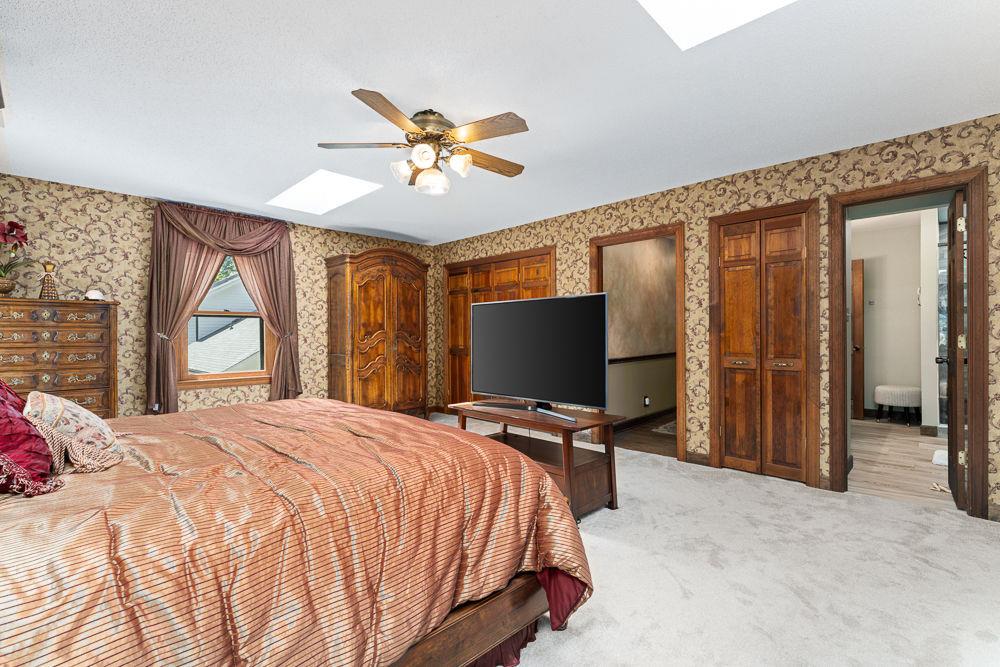2915 Ashford Road Northeast Brookhaven, GA 30319 - Photo 55 of 60 a bedroom with a bed and a flat screen tv
