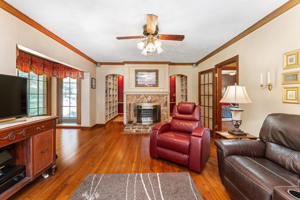 2915 Ashford Road Northeast Brookhaven, GA 30319 - Photo 59 of 60 a living room with furniture a flat screen tv and wooden floor