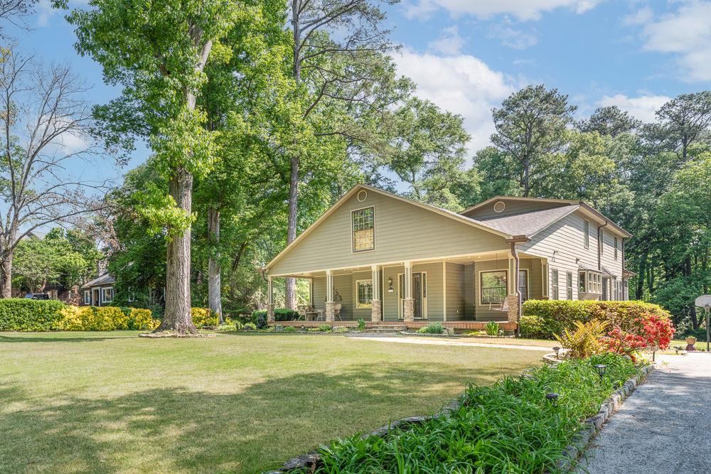 2915 Ashford Road Northeast Brookhaven, GA 30319 - Photo 7 of 60 a front view of a house with a garden