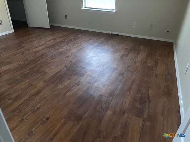 a view of room with wooden floor