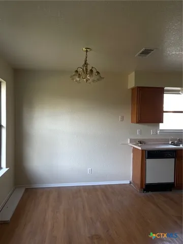an empty room with a kitchen