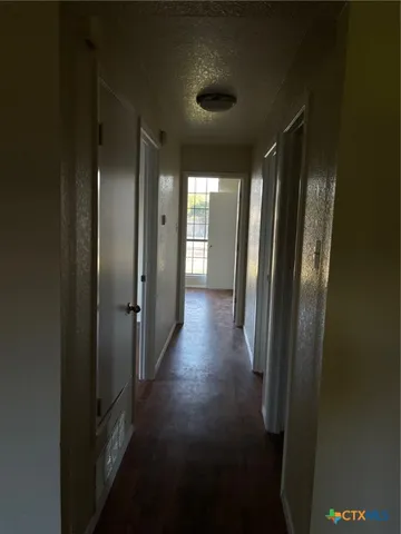 a view of gallery with wooden floor