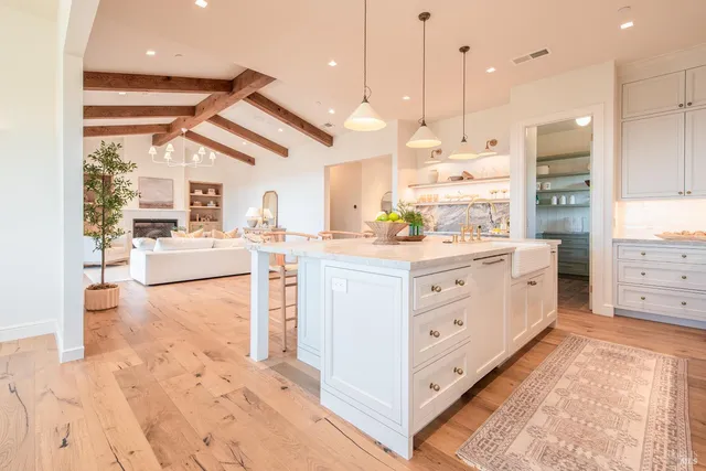 a kitchen with white cabinets and white appliances
